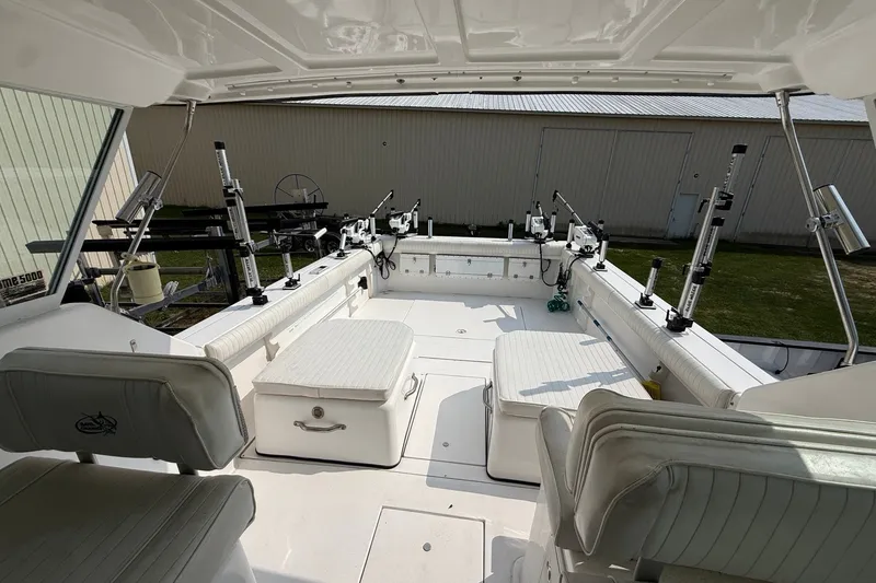 Slide: The Image of 2006 Baha Cruiser 299 SF boat interior with seating and fishing rod holders. - 14