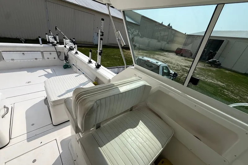 Slide: The Image of 2006 Baha Cruiser 299 SF boat interior with white seating and fishing rod holders. - 16