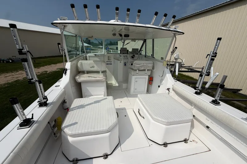 Slide: The Image of 2006 Baha Cruiser 299 SF boat interior with seating and fishing rod holders. - 8