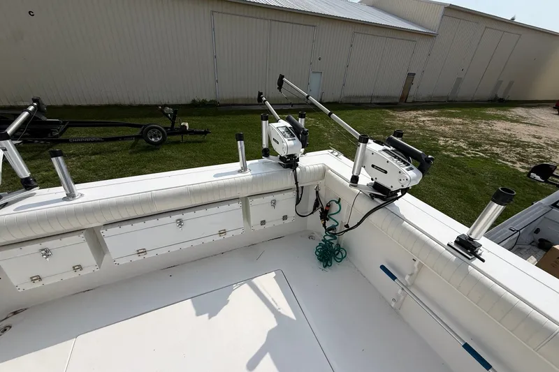 Slide: The Image of 2006 Baha Cruiser 299 SF boat deck with fishing rod holders and storage compartments. - 6