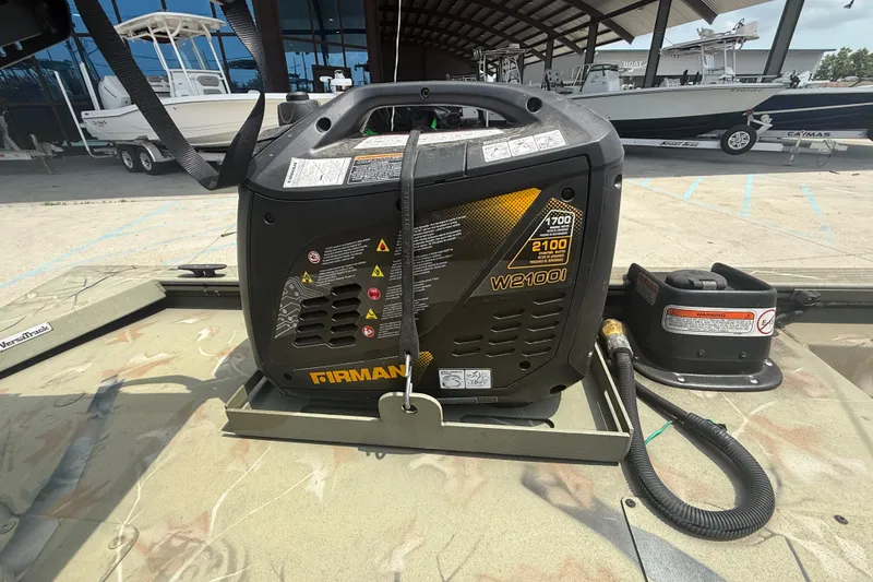 Slide: The Image of Portable generator on 2024 Tracker Grizzly 2072 MVX CC Sportsman boat deck. - 14