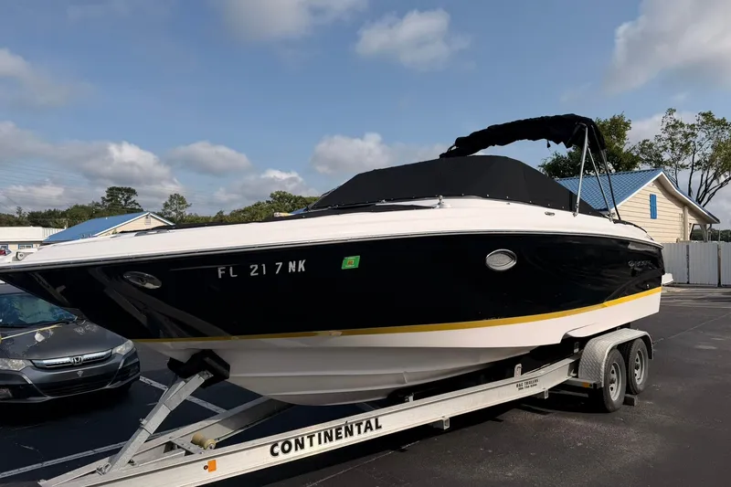 The Image of 2007 Regal 2700 Bowrider boat on trailer, parked outdoors under a clear sky. - 0