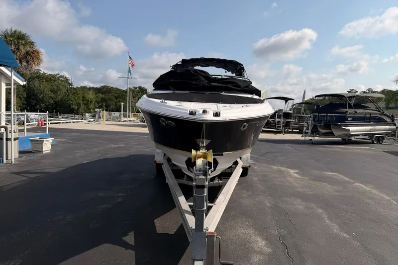 Slide: The Image of 2007 Regal 2700 Bowrider boat on trailer at marina, clear sky background. - 3