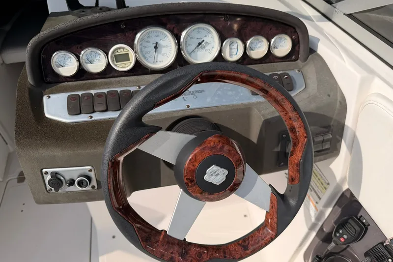 Slide: The Image of Steering wheel and dashboard of a 2007 Regal 2700 Bowrider boat. - 11