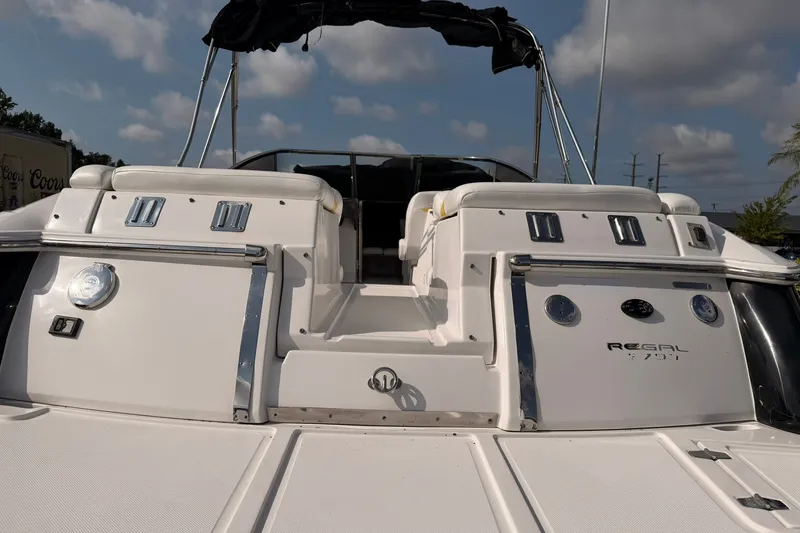 Slide: The Image of 2007 Regal 2700 Bowrider boat with sleek white deck and chrome accents. - 8