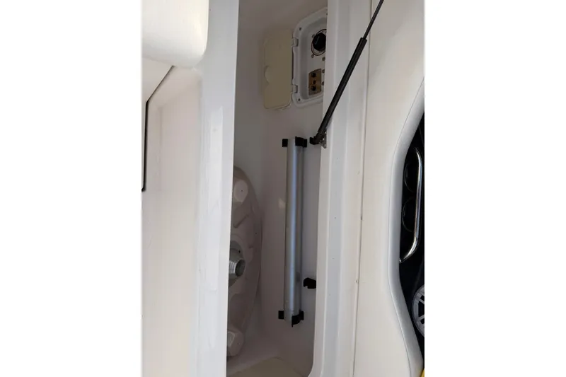 Slide: The Image of Storage compartment of a 2007 Regal 2700 Bowrider boat, featuring hydraulic support. - 17