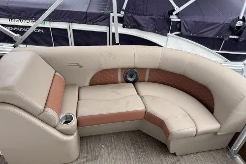 Slide: The Image of 2022 Bennington 22LSR boat interior with beige and brown seating. - 4