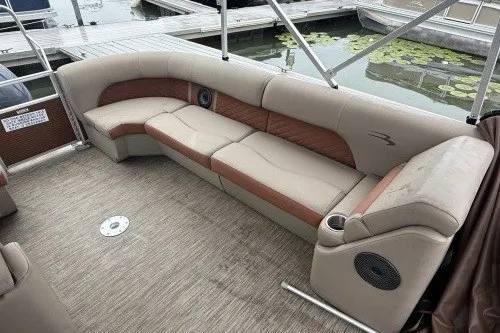 Slide: The Image of 2022 Bennington 22LSR pontoon boat interior with beige seating and lake view. - 6