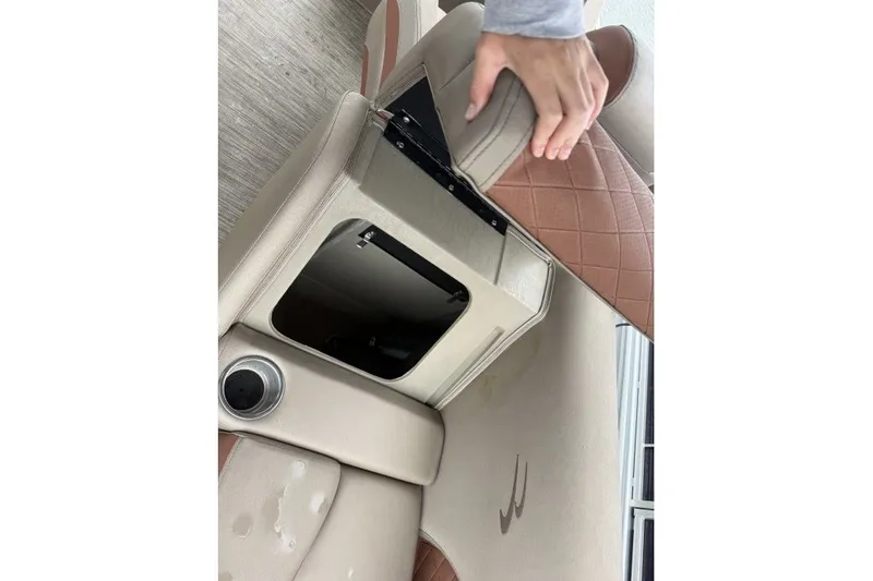 Slide: The Image of 2022 Bennington 22LSR boat seat storage compartment with cup holder and quilted upholstery. - 10