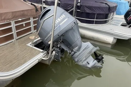 Slide: The Image of 2022 Bennington 22LSR pontoon boat with Yamaha outboard motor docked in water. - 3