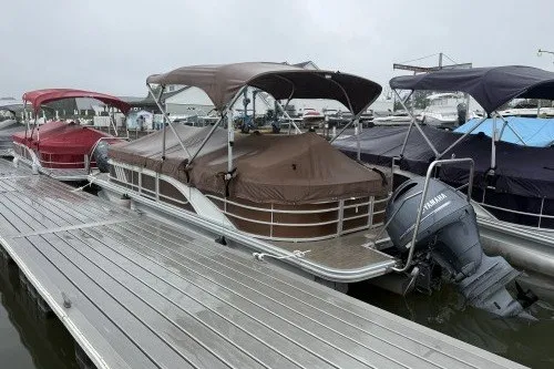 The Image of 2022 Bennington 22LSR pontoon boat docked with Yamaha outboard motor. - 1