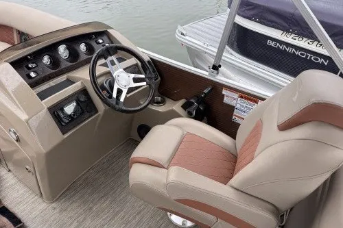 Slide: The Image of 2022 Bennington 22LSR boat interior with steering wheel and captain's chair. - 5