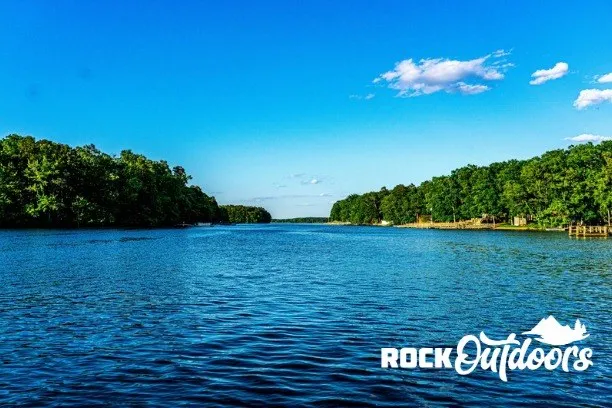 Slide: The Image of A calm river with wooded banks under a clear blue sky. - 5