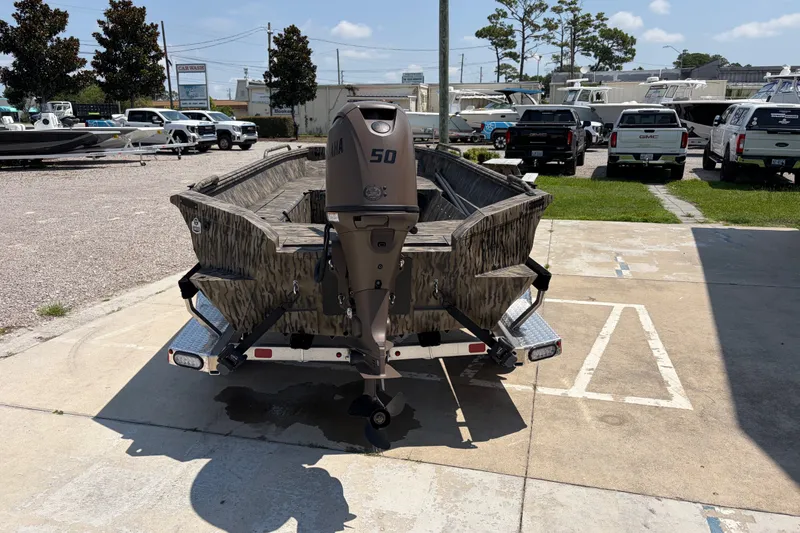 Slide: The Image of 2026 Excel 1651 River Warrior boat with Yamaha 50 engine, parked outdoors. - 3