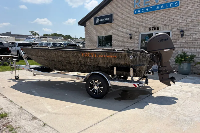 Slide: The Image of 2026 Excel 1651 River Warrior boat with Yamaha motor at dealership. - 2