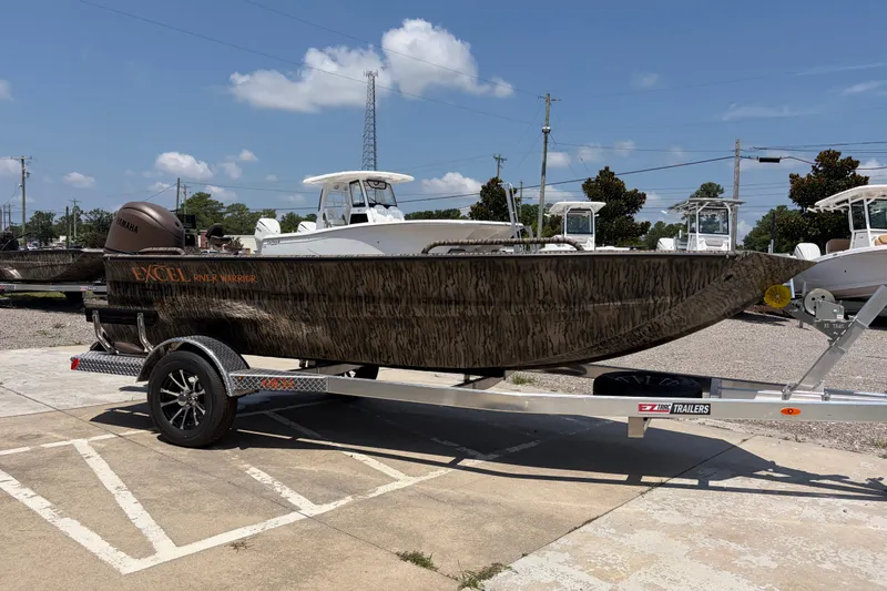 Slide: The Image of 2026 Excel 1651 River Warrior boat on trailer, parked outdoors under clear sky. - 5