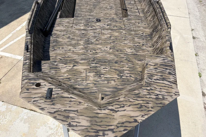 Slide: The Image of 2026 Excel 1651 River Warrior boat with camouflage pattern on a concrete surface. - 6