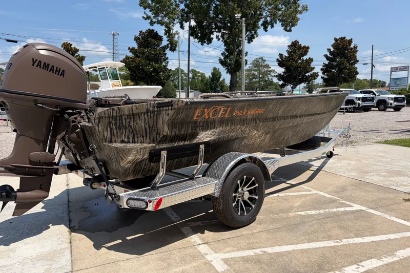 Slide: The Image of 2026 Excel 1651 River Warrior boat on trailer with Yamaha motor, parked outdoors. - 4