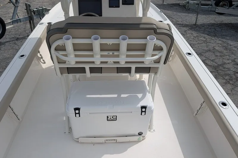 Slide: The Image of 2027 Key West 250 Bay Reef boat interior with seating and cooler storage. - 13