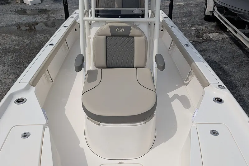 Slide: The Image of 2027 Key West 250 Bay Reef boat interior with cushioned seating and rod holders. - 20
