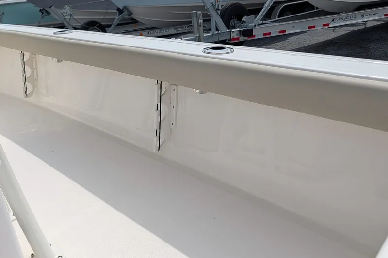 Slide: The Image of 2027 Key West 250 Bay Reef boat interior with rod holders and sleek design. - 14