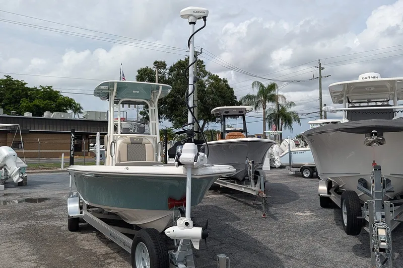 Slide: The Image of 2027 Key West 250 Bay Reef boat on trailer in dealership lot, surrounded by other boats. - 24