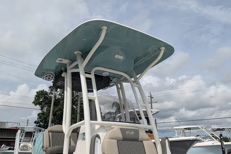 Slide: The Image of 2027 Key West 250 Bay Reef boat with T-top under cloudy sky. - 26