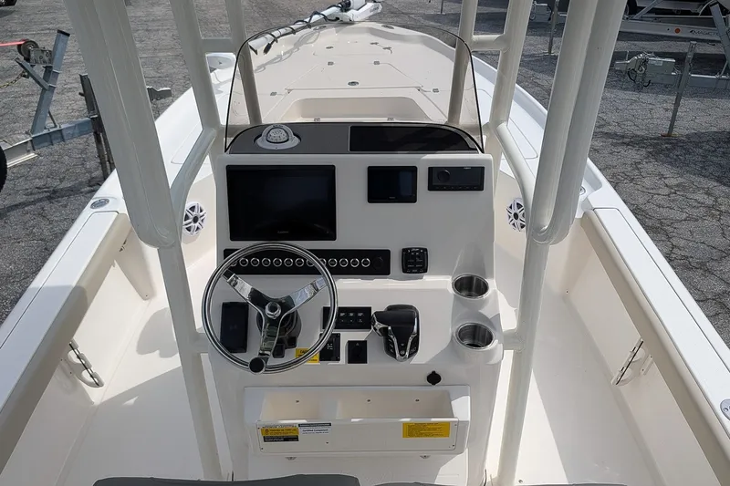 Slide: The Image of 2027 Key West 250 Bay Reef boat console with steering wheel and navigation controls. - 17