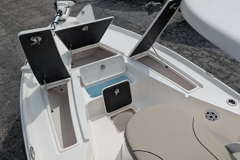 Slide: The Image of 2027 Key West 250 Bay Reef boat with open storage compartments and seating area. - 23
