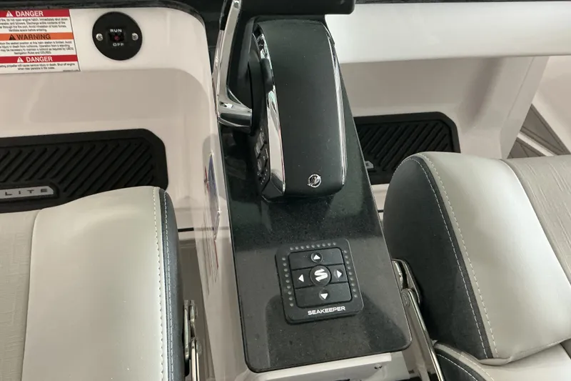 Slide: The Image of Center console of 2027 Monterey Elite 27 SD boat with Seakeeper control panel. - 13