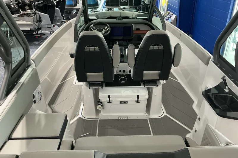 Slide: The Image of Interior of 2027 Monterey Elite 27 SD boat with modern seating and dashboard. - 8