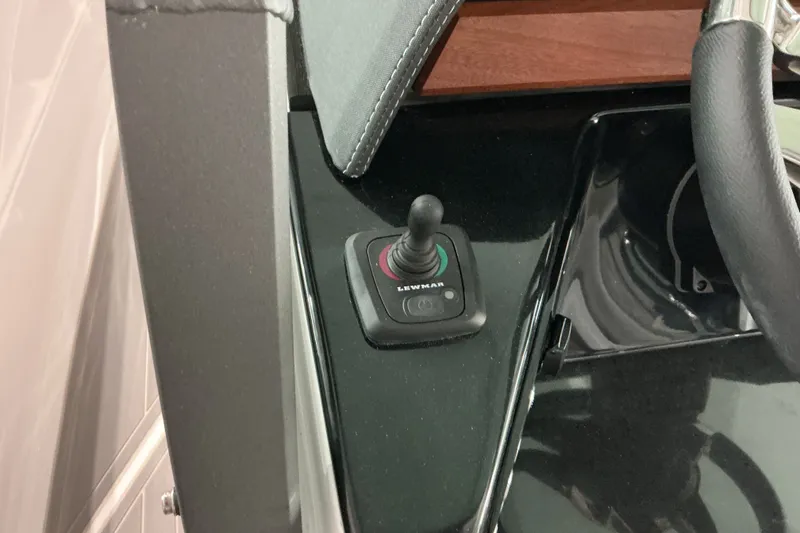 Slide: The Image of Joystick control on 2027 Monterey Elite 27 SD boat dashboard. - 14