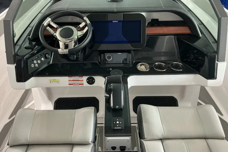 Slide: The Image of Cockpit of 2027 Monterey Elite 27 SD boat with modern steering and control panel. - 10