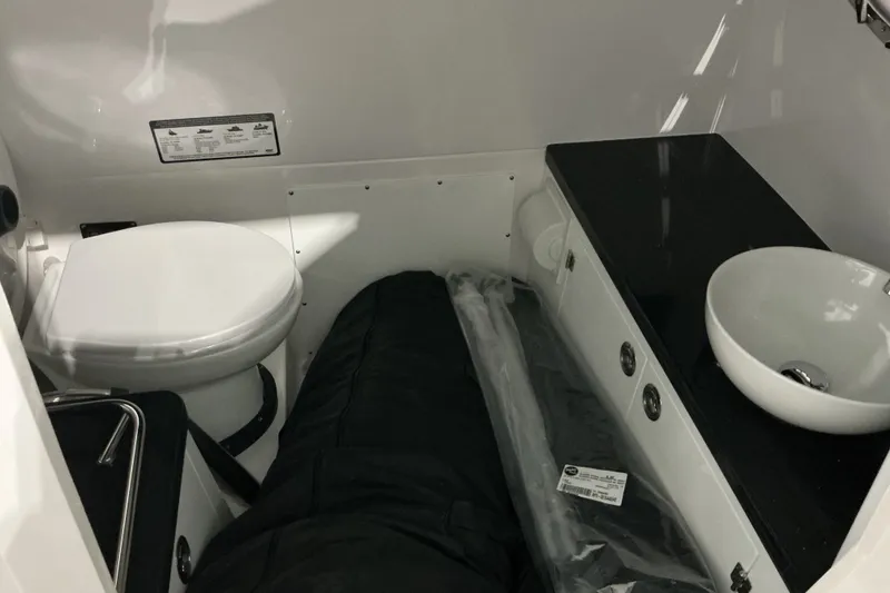 Slide: The Image of Interior of 2027 Monterey Elite 27 SD boat with toilet and sink. - 16