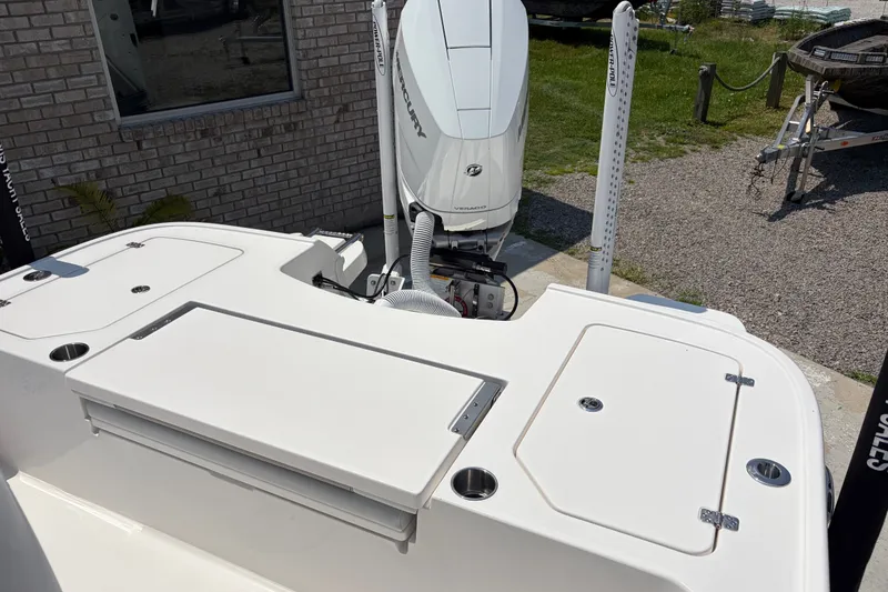 Slide: The Image of The image shows the stern of a Caymas 28 HB boat with a Mercury outboard motor. - 12