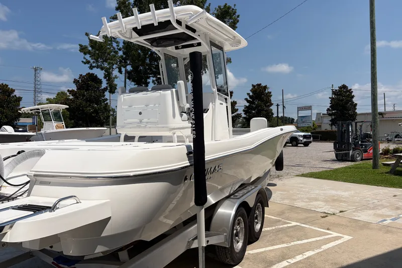 Slide: The Image of A white 2026 Caymas 28 HB boat is on a trailer in an outdoor setting. - 5