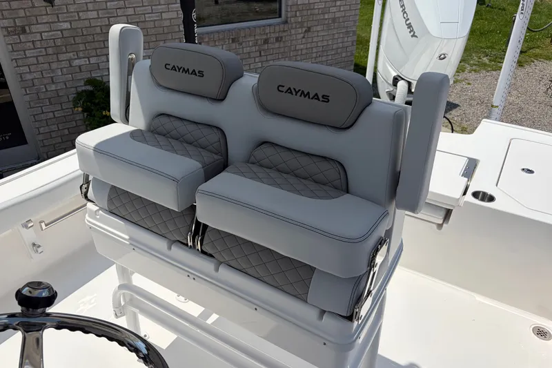 Slide: The Image of The 2026 Caymas 28 HB features luxurious, cushioned seats with quilted design and armrests. - 11