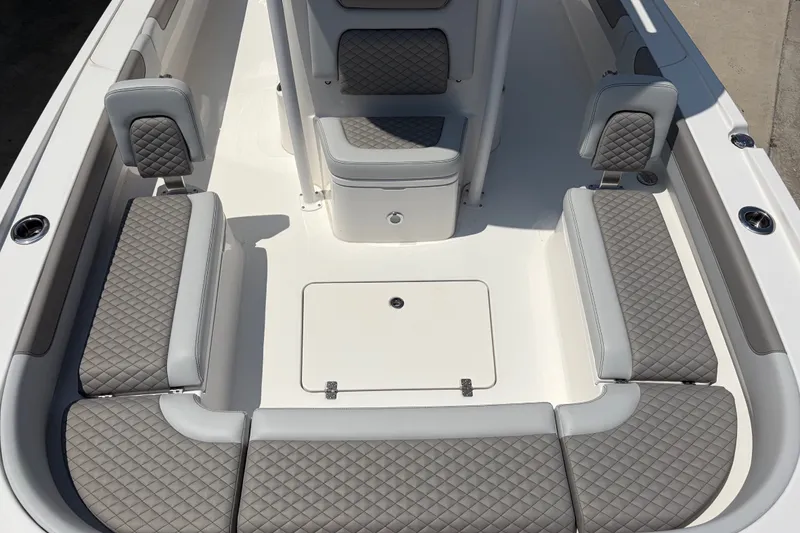 Slide: The Image of The image shows the cockpit of a Caymas 28 HB boat with gray quilted upholstery. - 9