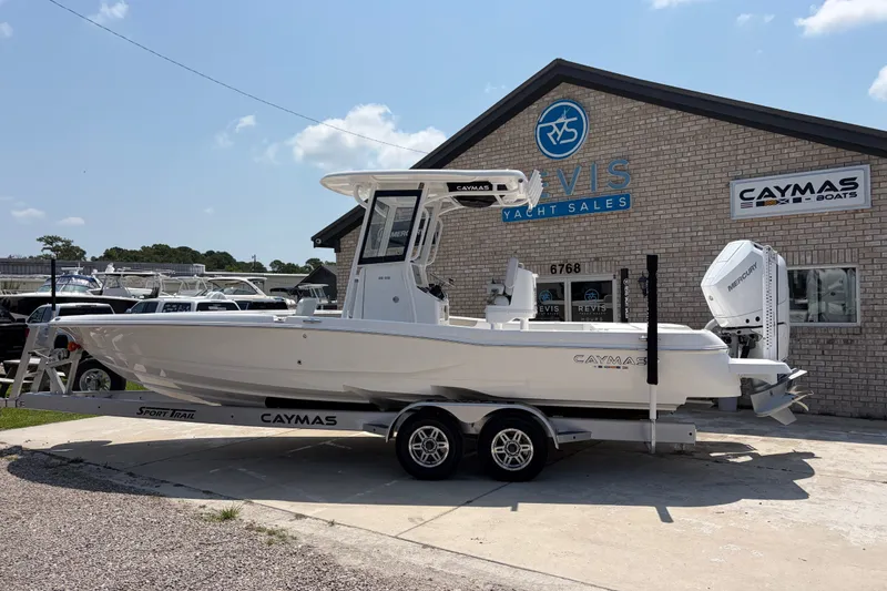 Slide: The Image of A white Caymas 28 HB boat on a trailer in front of a building labeled "Davis Yacht Sales." - 2