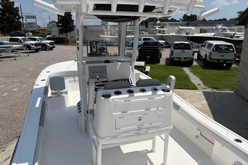 Slide: The Image of The image shows a 2026 Caymas 28 HB boat with a modern helm and fishing rod holders. - 13