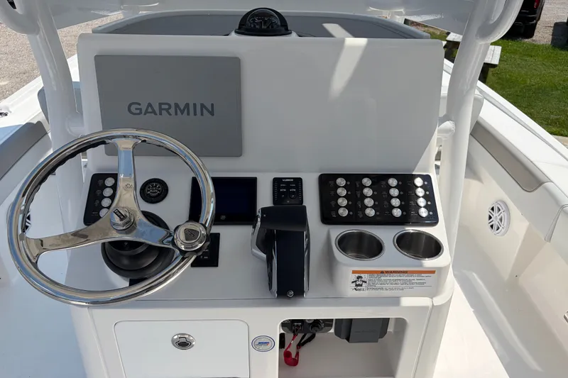 Slide: The Image of The image shows the helm of a Caymas 28 HB boat with Garmin navigation. - 14