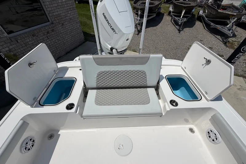 Slide: The Image of The image shows the stern of a Caymas 28 HB boat with two open storage compartments and a seat. - 16