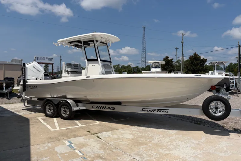 Slide: The Image of 2026 Caymas 28 HB on a trailer, white hull, T-top, dual outboard engines. - 6