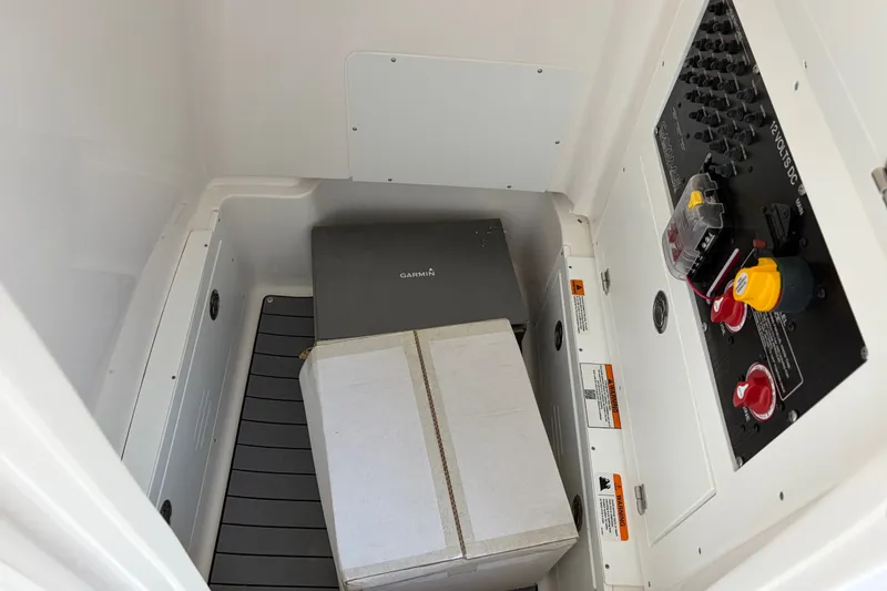 Slide: The Image of Interior of a Caymas 28 HB boat with control panel and boxes. - 10