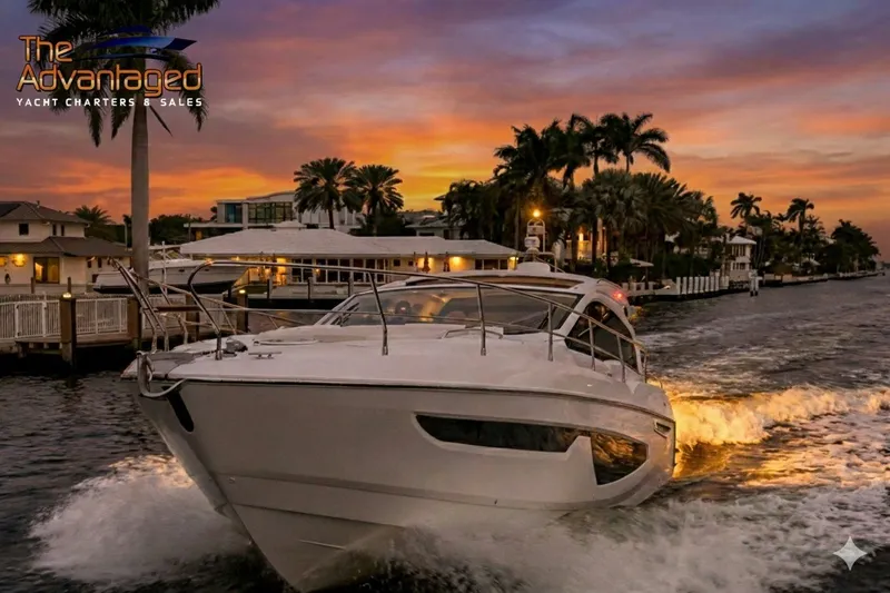 Slide: The Image of 2024 Sessa Marine C44 Cruiser navigating at sunset near waterfront homes. - 14