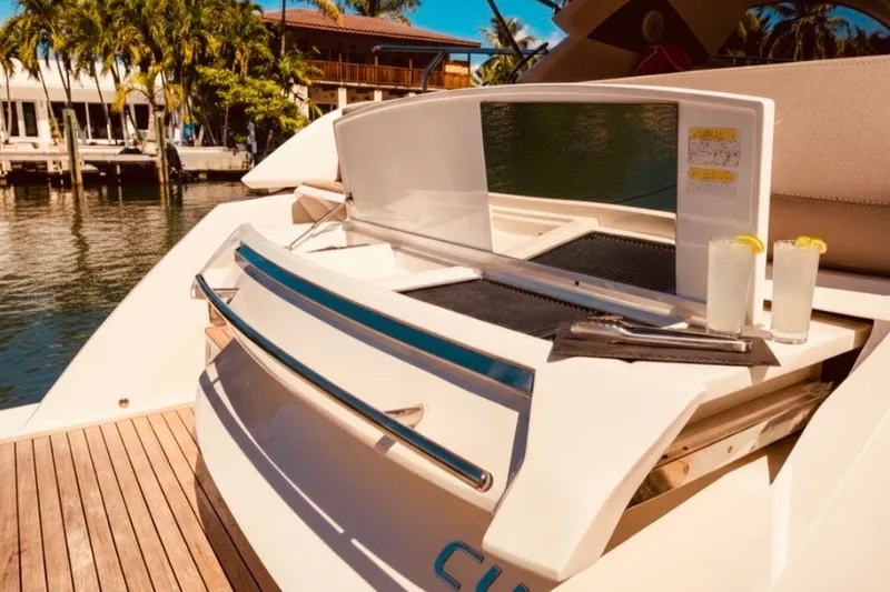 Slide: The Image of 2024 Sessa Marine C44 Cruiser with outdoor bar setup and refreshing drinks. - 9