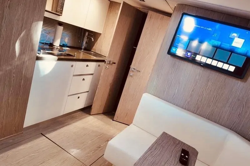Slide: The Image of Interior of 2024 Sessa Marine C44 Cruiser with modern kitchen and wall-mounted TV. - 3