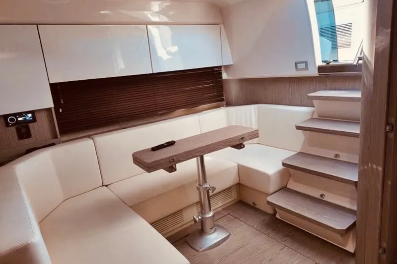 Slide: The Image of Luxurious interior of 2024 Sessa Marine C44 Cruiser with modern seating and wooden accents. - 2