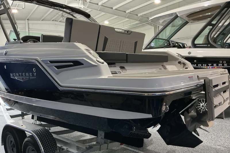 Slide: The Image of 2027 Monterey Elite 25 SD boat displayed indoors on a trailer. - 5