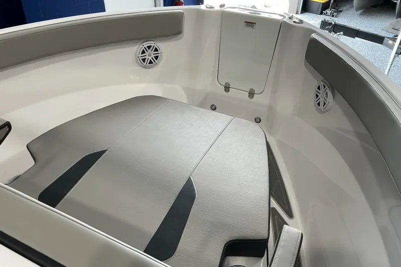 Slide: The Image of Interior view of 2027 Monterey Elite 25 SD boat, featuring cushioned seating and speakers. - 11
